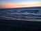The red of the setting sun reflecting on the beach.