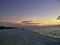 The setting sun reflecting on the southern clouds